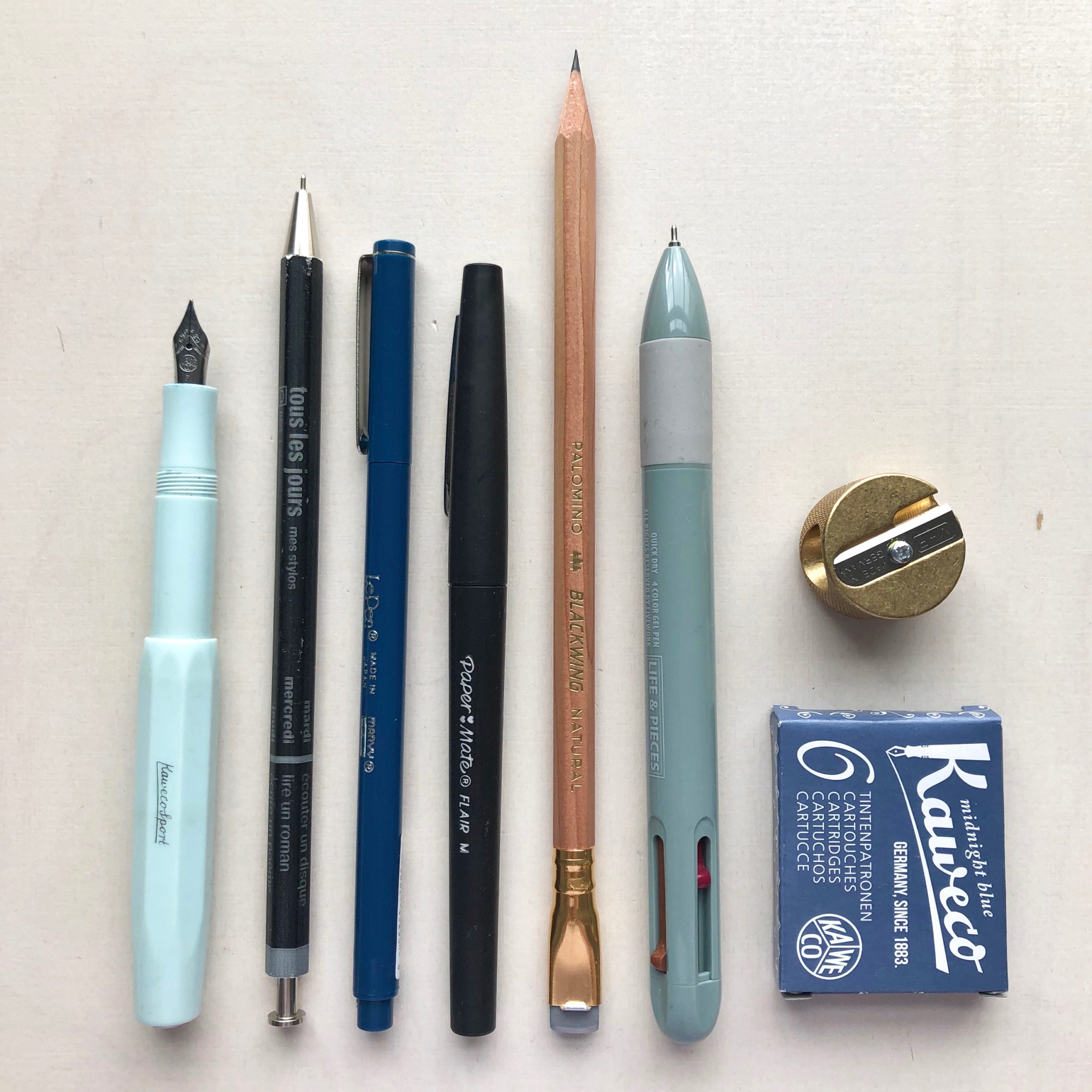 a selections of pens and pencils on a desk