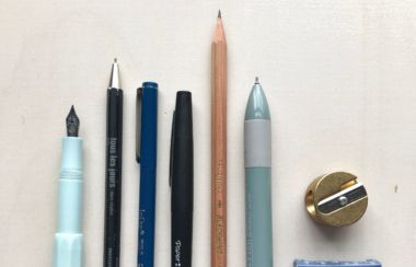 a selections of pens and pencils on a desk